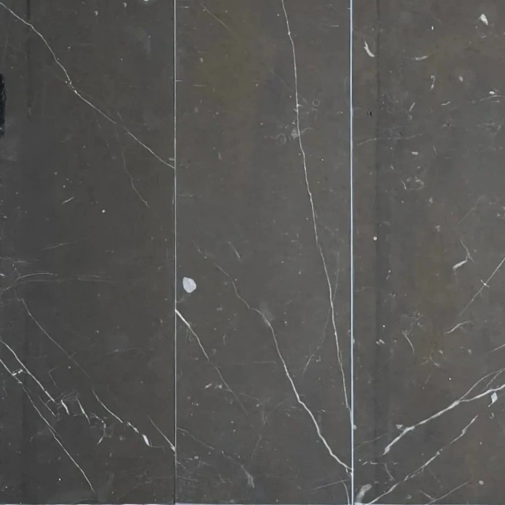 Dark marble tiles with white veining from Nero Marquina Black Marble 4X12 collection