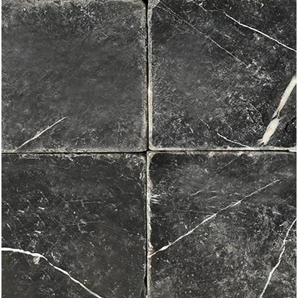 Four black marble tiles of Nero Marquina in a 4X4 tumbled finish