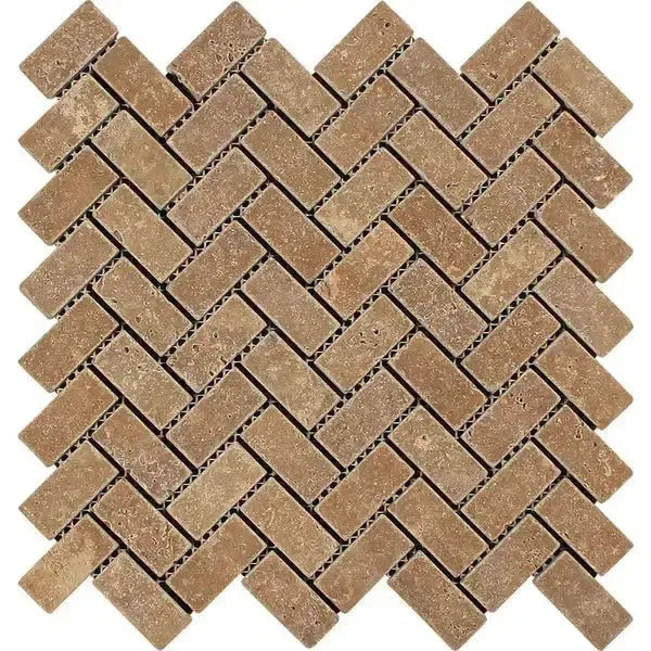 Herringbone pattern of Noce Travertine 1X2 brown stone tiles in a mosaic design