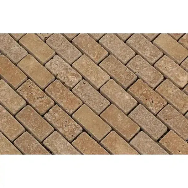 Herringbone pattern of tan brick pavers in Noce Travertine Mini-Brick Mosaic