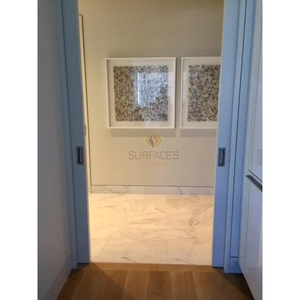 Hallway featuring framed artwork and Oriental White Asian Statuary marble mosaic