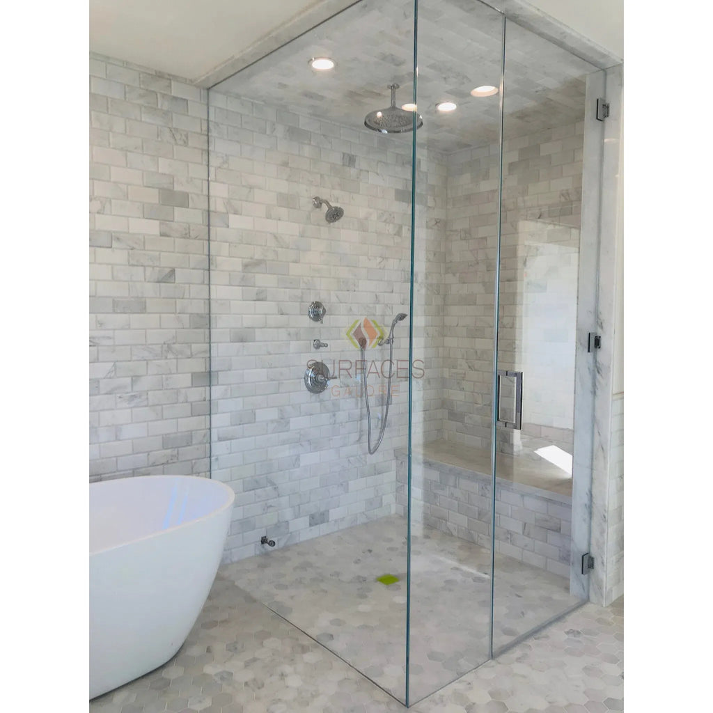 Glass-enclosed shower featuring Oriental White Asian Statuary marble tile bullnose liner