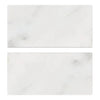 Two rectangular Oriental White Asian Statuary Marble 3X6 Tumbled tiles on display