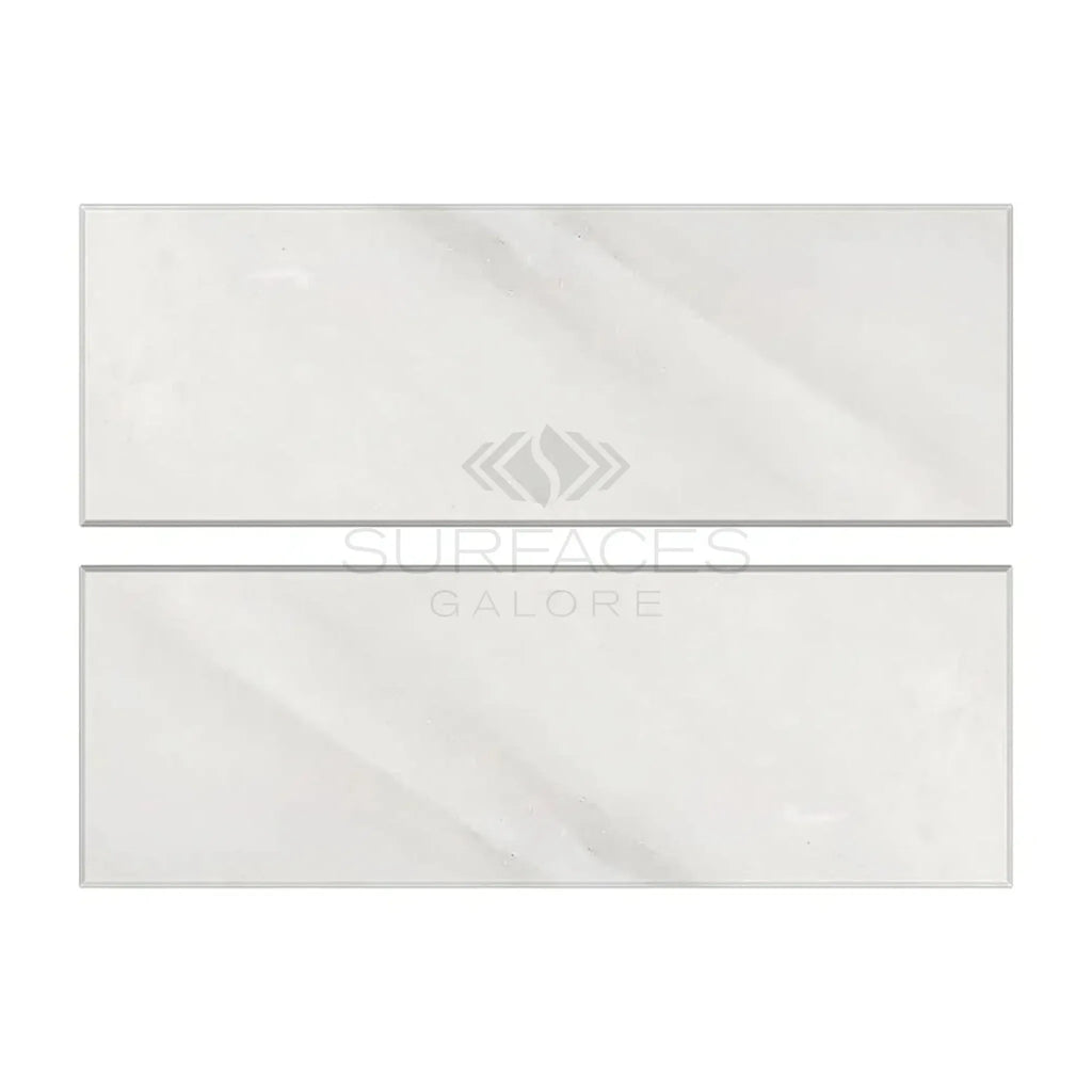 Two light-colored rectangular tiles of Oriental White Asian Statuary Marble 4X12