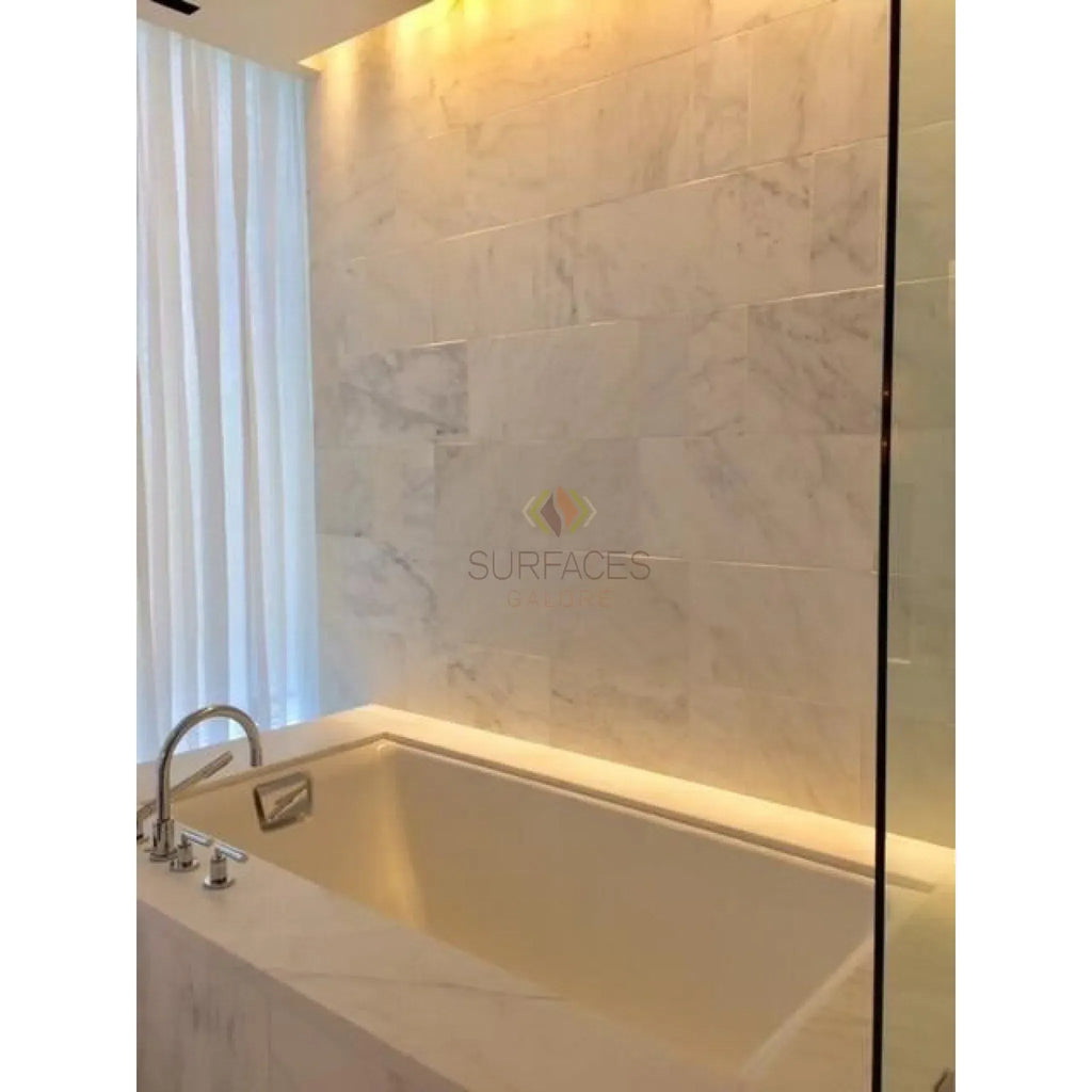 Modern white bathtub with marble surround featuring Oriental White Marble Shower Corner Shelf