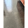 Dark, speckled floor tiles in Pierre Bleue 12X24 Brushed Marble for elegant interiors