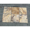 Six stone-look tiles in brown and gray patterns on Scabos Travertine wall plate