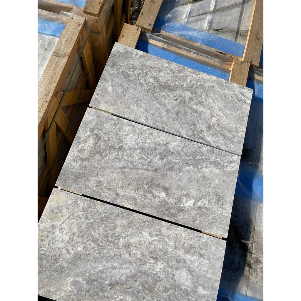 Gray marble tiles from the Silver Gray Travertine 1/2X12 Pencil Liner Honed product