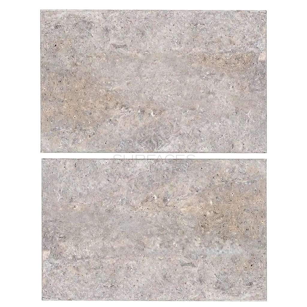 Two gray stone tiles from the Silver Gray Travertine 16X24 Tile Tumbled collection