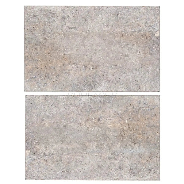 Two gray stone tiles from the Silver Gray Travertine 16X24 Tile Tumbled collection