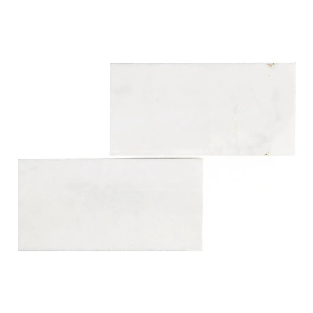 Two Snow White Marble 6X12 Polished rectangular tiles on a neutral background