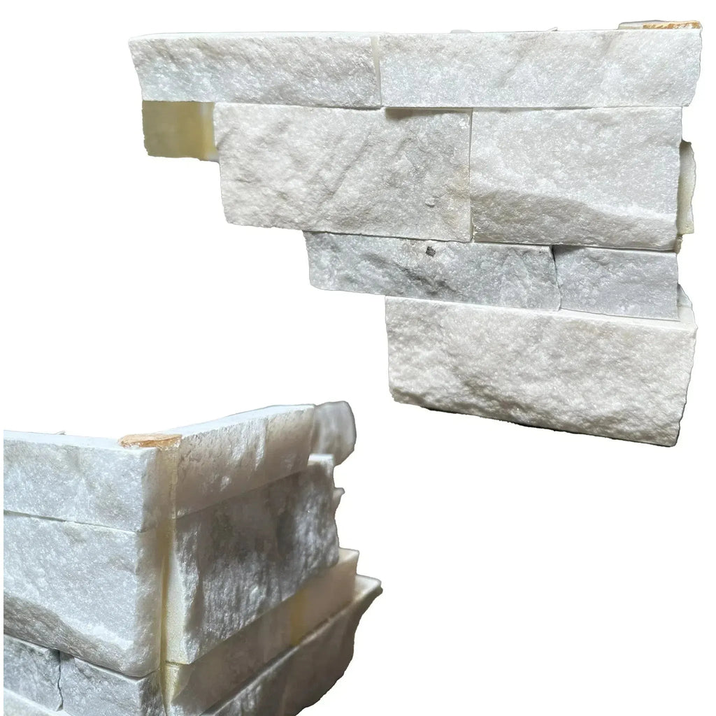 Stacked white stone corner pieces from Split-Face Panel Travertine Set for sale