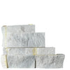 Stacked white stone blocks from Split-Face Panel Travertine Set for clearance sale