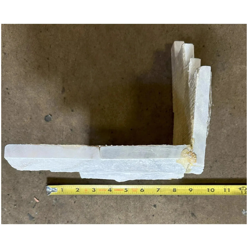 White L-shaped trim piece with tape measure for Split-Face Panel Travertine Set