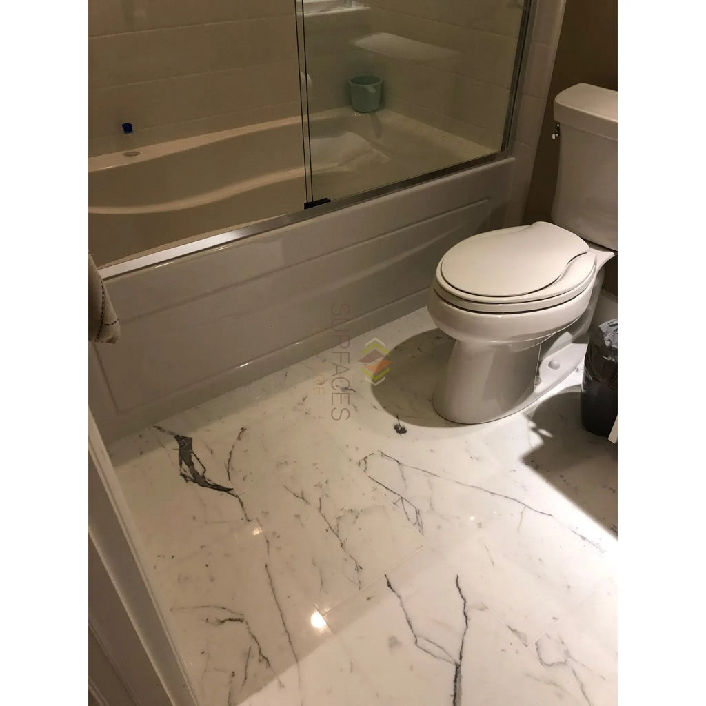 White dual flush toilet showcased with Statuary-Statuario White Italian Marble 12X12