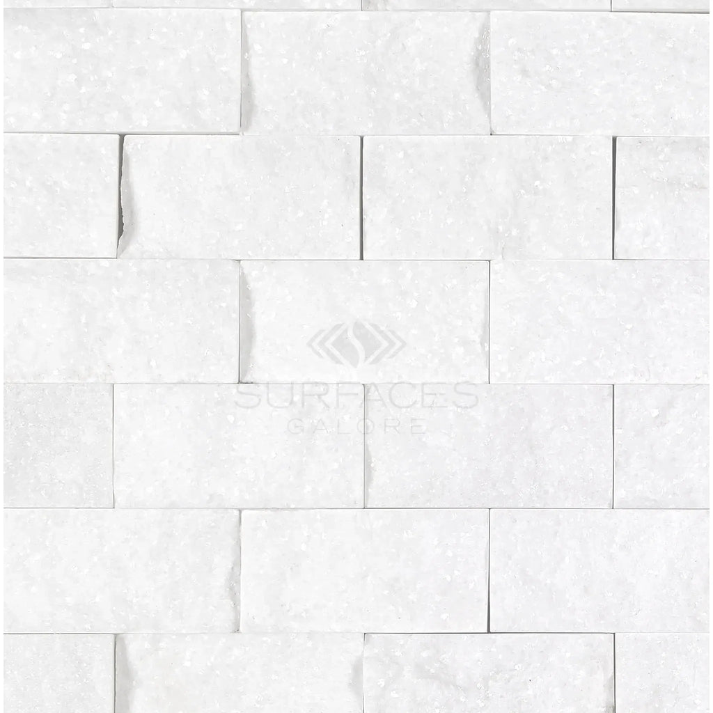 Thassos White 1X2 Brick Mosaic Marble Split-Faced on a white brick wall