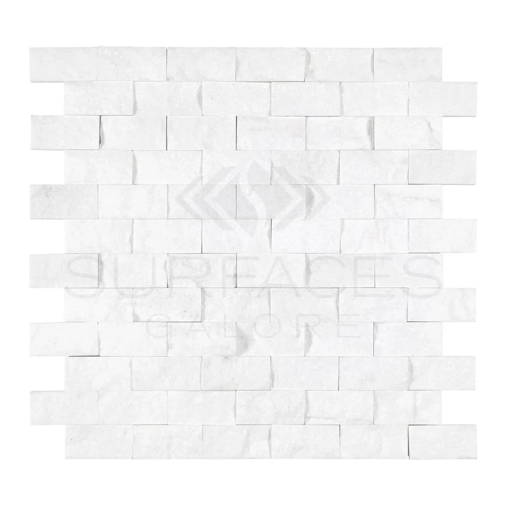 Thassos White 1X2 Brick Mosaic Marble Split-Faced on a white brick wall panel