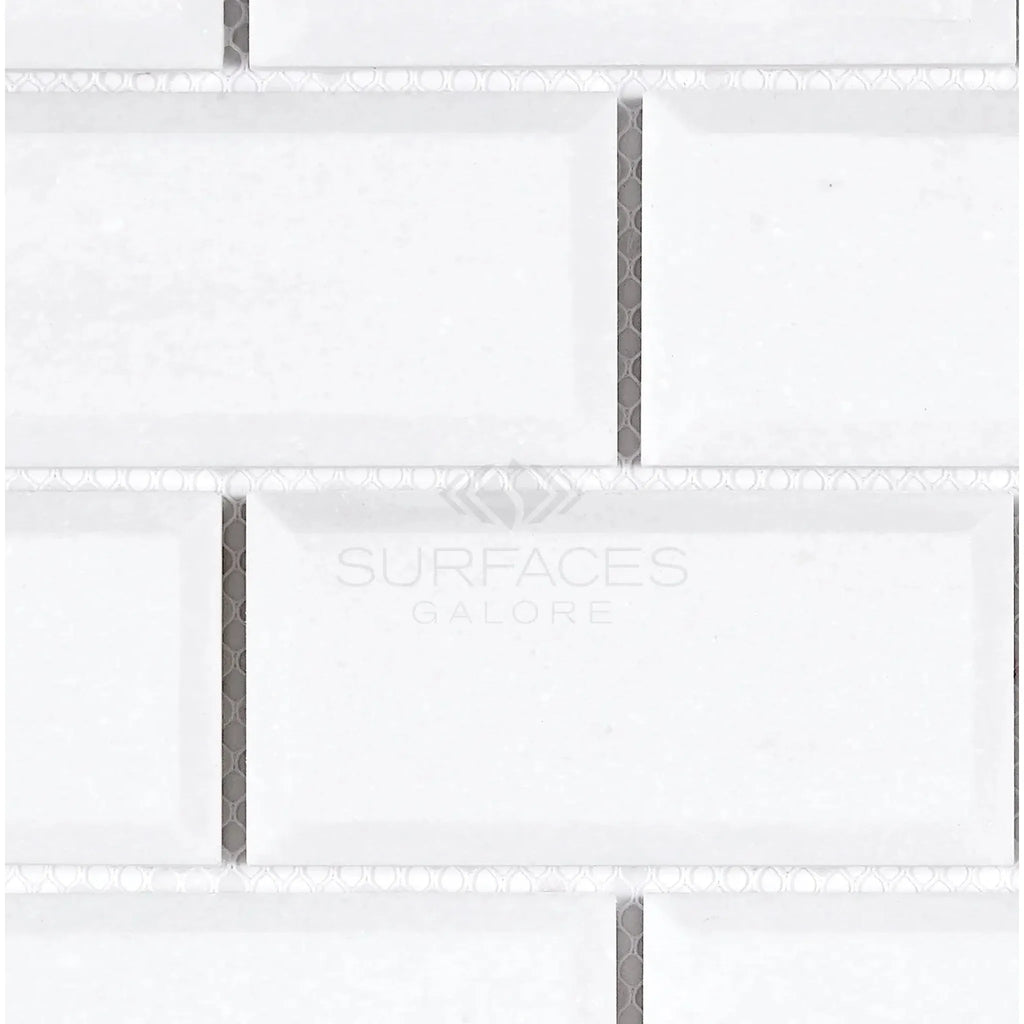 White beveled subway tile from Thassos White 2X4 Deep-Beveled Brick Mosaic Marble