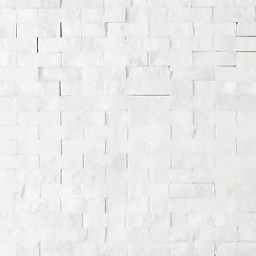 Thassos White 3/8X1 Mini-Brick Mosaic Marble Split-Faced on a white brick wall