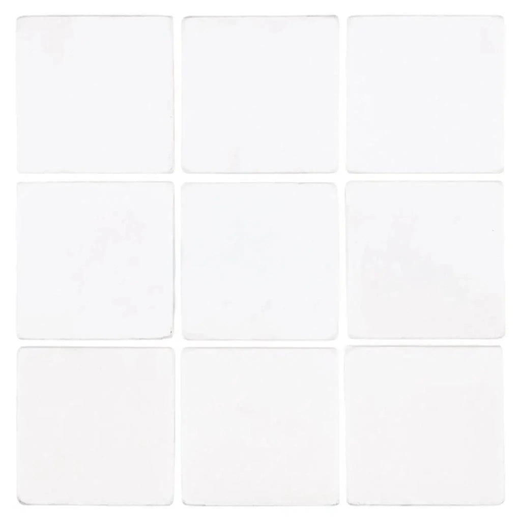 Nine white square Thassos White 4X4 Marble Tumbled tiles arranged in a grid pattern