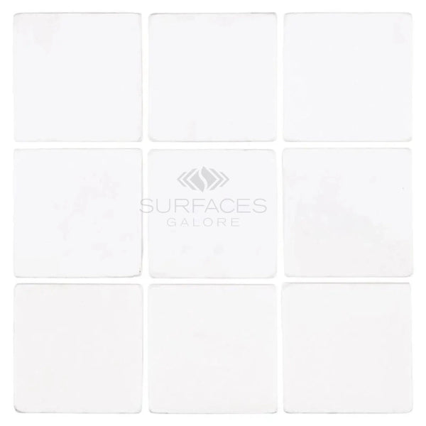 Nine white square Thassos White 4X4 Marble Tumbled tiles arranged in a grid pattern