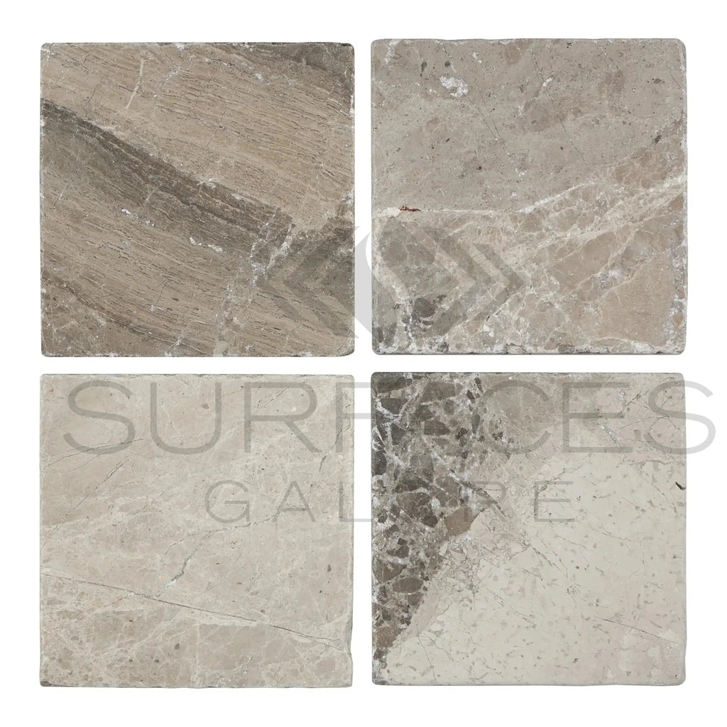 Four square Tundra Gray 12X12 Marble Tumbled tiles showcasing a sleek design