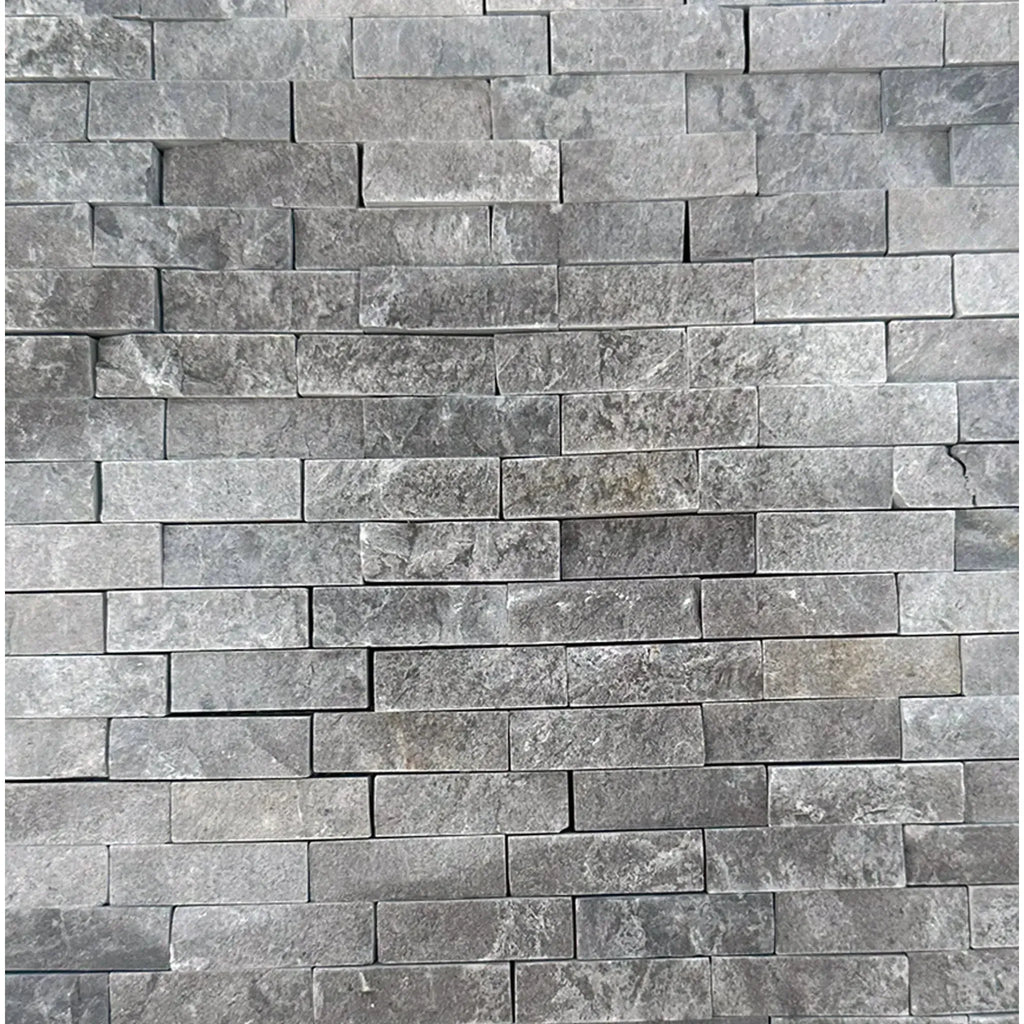 Gray stacked stone wall of Tundra Gray 5/8X2 Brick Marble Mosaic Split-Faced