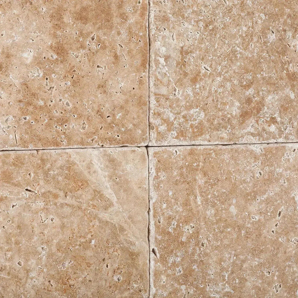 Four Walnut Travertine 12X12 Tumbled tiles showcasing natural elegance and texture