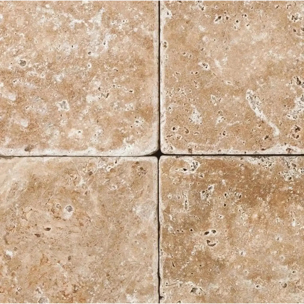 Four Walnut Travertine 12X12 Tumbled tiles showcasing natural texture and color