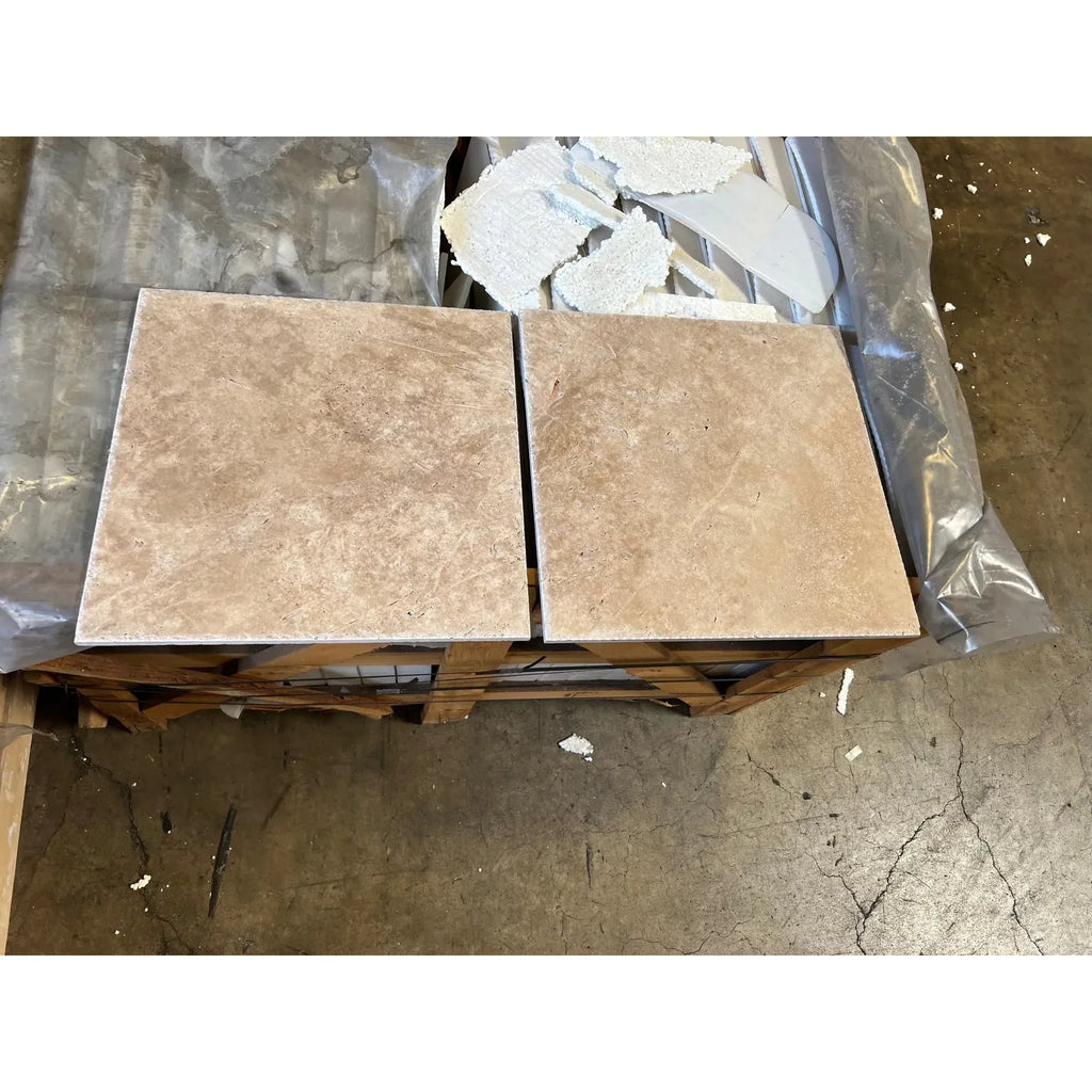 Two tan ceramic tiles from Walnut Travertine 1X2 Brick Mosaic Tile Tumbled collection