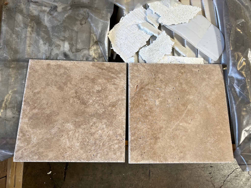 Two square beige textured tiles on the Walnut Travertine Double DUPLEX Switch Wall Plate