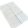 Six light-colored tiles of White Pearl/Botticino Beige Marble 12X12 Tumbled