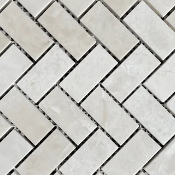 Herringbone pattern of light-colored rectangular tiles in White Pearl/Botticino Beige Marble