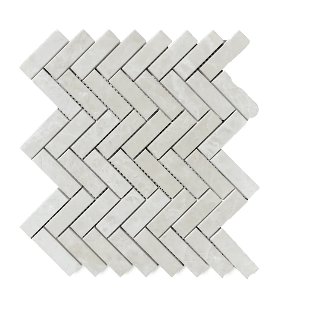 Herringbone pattern of White Pearl and Botticino Beige marble tiles in polished finish