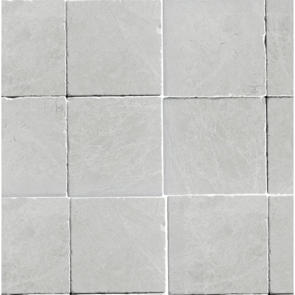 Arrangement of square light gray tiles in White Pearl/Botticino Beige Marble 4X4 Tumbled