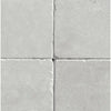 Four light gray square tiles of White Pearl/Botticino Beige Marble 6X6 Tumbled